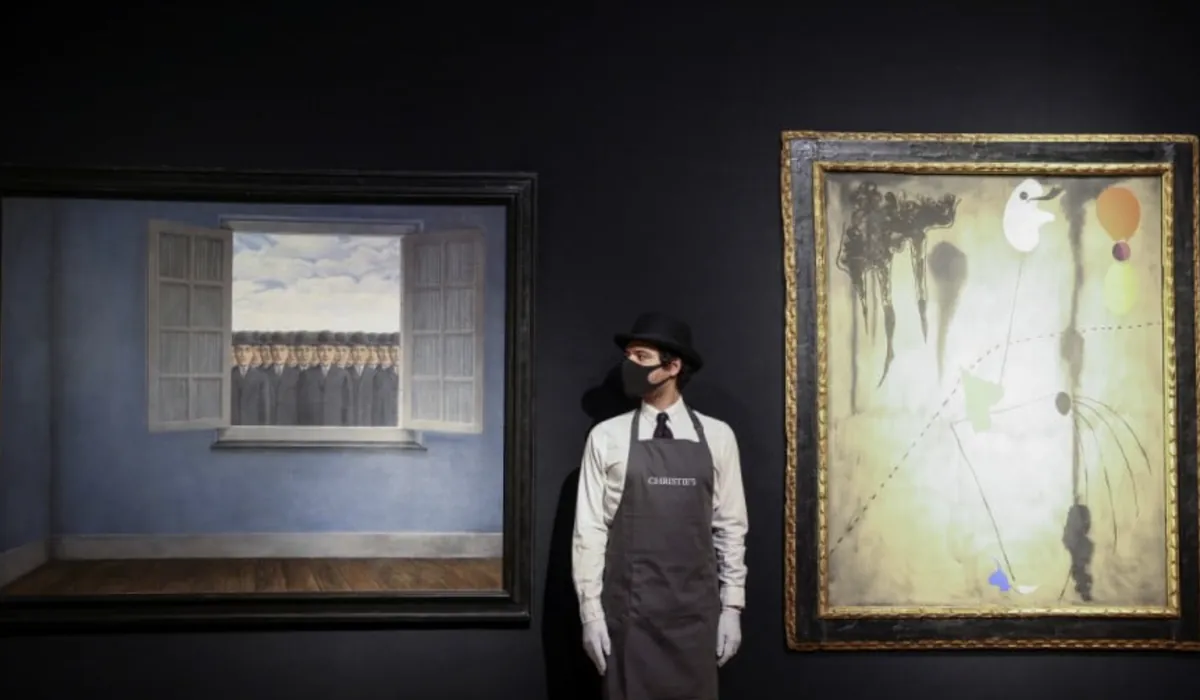 A Christie's saleroom, two paintings on display